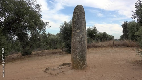 Isolated single Menhir stone near the Almendres Cromlech megalithic complex at Evora district.  Guadalupe, Evora, Alentejo, Portugal. photo