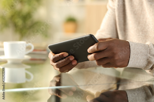 Black man hands playing video game on smartphone