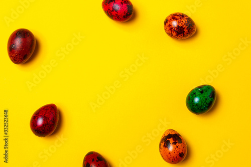 Easter card concept. Lot of easter eggs on a yellow background. Background with space to text. Easter mocku up