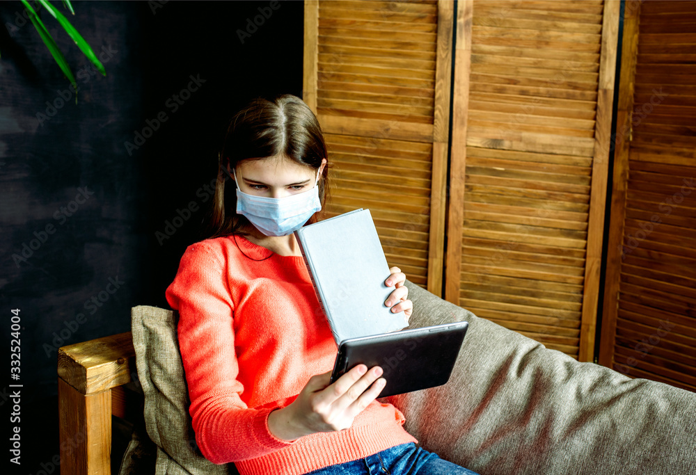 Obraz premium Student on laptop and tablet, online distance education, coronavirus and pandemic. covid-19.Young girl learning foreign languages, digital self education, studying online
