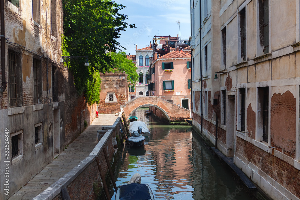View to Venetian canal, promenade of Grimani, fondamenta Grimani, and Ponte Moro, Venice, Italy