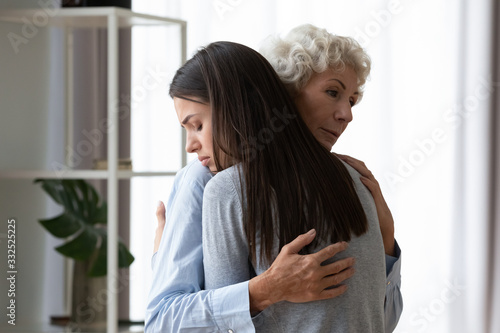 Fotografie Supportive old mature mom hug comfort upset depressed grown-up daughter show lov