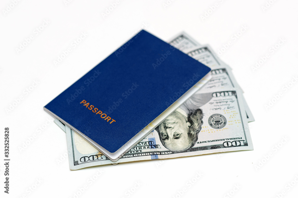 Blue biometric passport with cash in dollars on white background. Documents, travel, business concept Blue biometric passport with cash in dollars on white background. Documents, travel, business concept