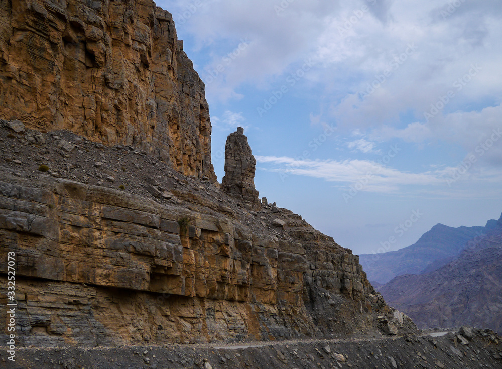 Face shaped rock statue on Jebel Say Road in evening light leading up to Jebel Harin in Musandam