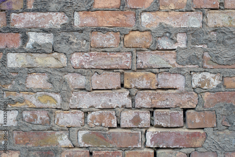 brick wall of a building, texture background. patterns and cracks brick wall of a building, texture background. patterns and cracks