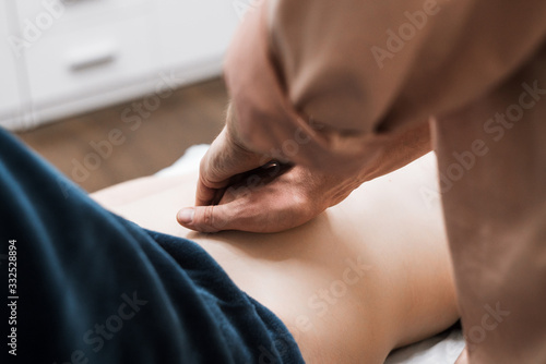 a man does a woman a massage of the abdomen, osteopathy 1 © Alina