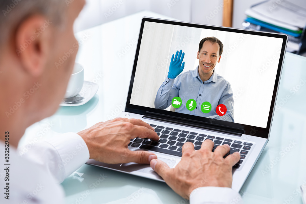 Businessman Videoconferencing With Doctor On Laptop