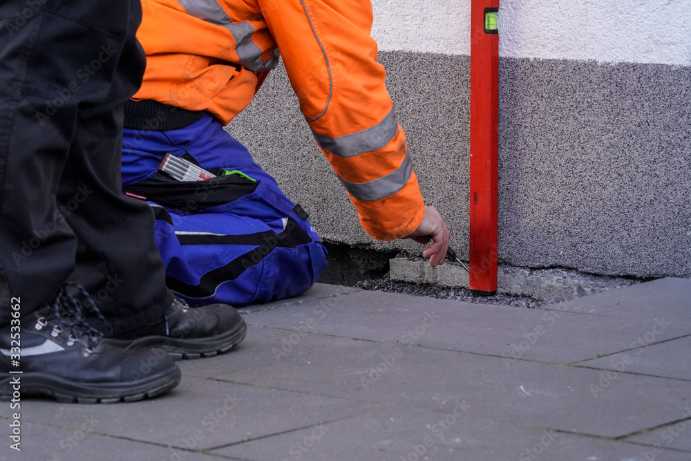 Bauarbeiter mit Wasserwaage Bau Geodäsie Digital Wasserwaage