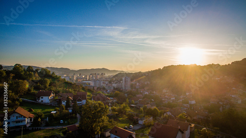 Aerial view of downtown Tuzla at sunset, Bosnia. City photographed by drone, traffic and objects , landscape.Tuzla city photographed by drone from air. Buildings near park. Old balkan city with large 