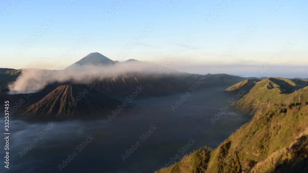Beautiful colorful sunrise sunset over Mount Bromo and wild island in Mount Bromo National Park Beautiful colorful sunrise sunset over Mount Bromo and wild island in Mount Bromo National Park