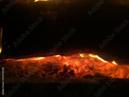 White Hot Glowing Coals, Embers, White Ash, and flames is a Smoldering Fireplace