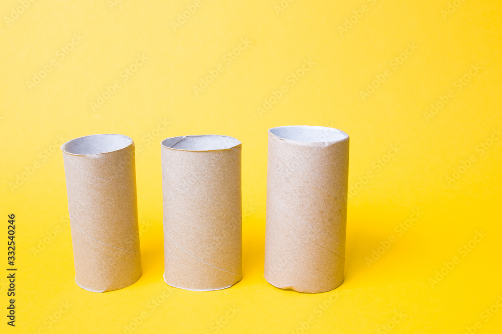 three toilet paper bushes on a yellow background copy space, toilet paper has ended, crisis 2020, a joke about the hype three toilet paper bushes on a yellow background copy space, toilet paper has ended, crisis 2020, a joke about the hype