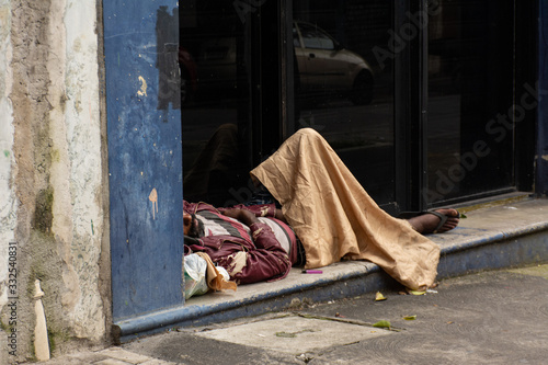homeless man sleeps on the streets succesptible to covid-19 in SP