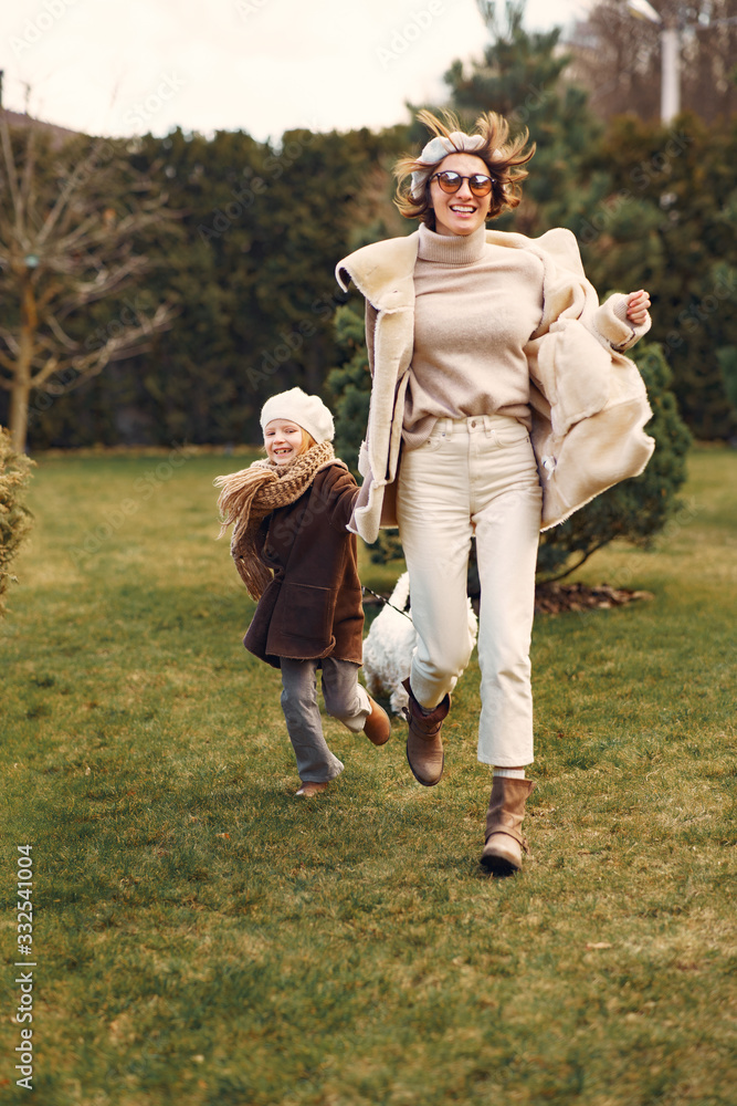 Obraz premium Family in a garden. Mother with daughter. People with little dog.