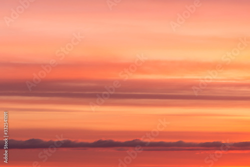 Bright soft sunrise, sunset orange yellow red sky with clouds background texture © Viktor Iden