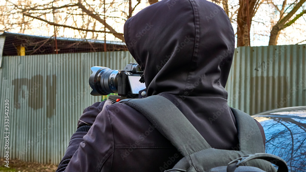 Street photographer shoots from monopod Street photographer shoots from monopod