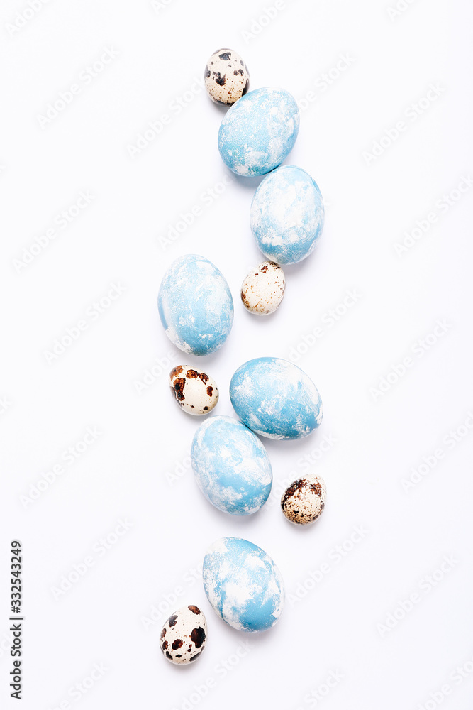 Stylish eggs with ombre blue marble stone effect on white background Stylish eggs with ombre blue marble stone effect on white background