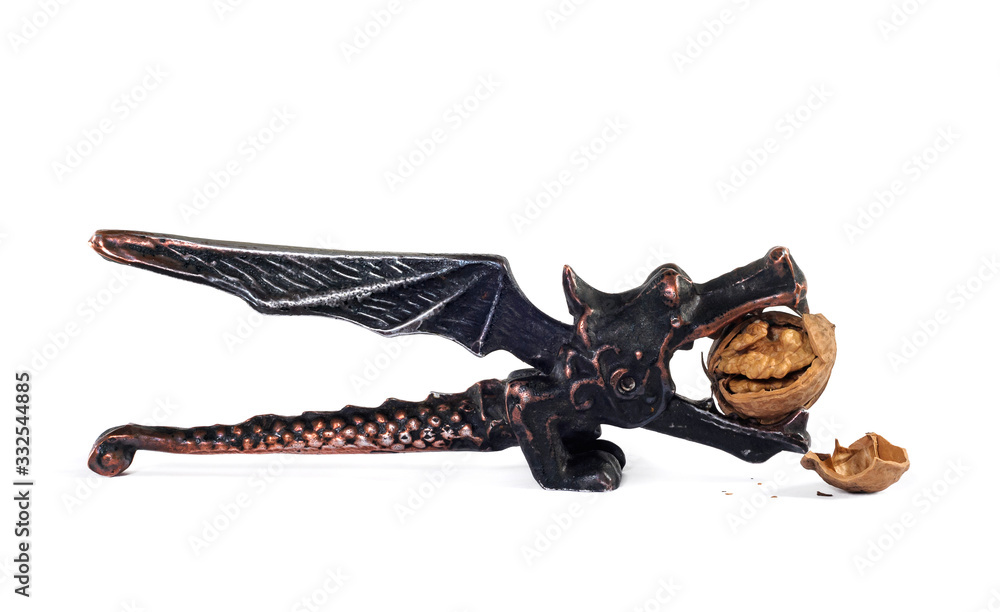 Obraz premium Dragon nutcracker and crushed walnut on a white fon