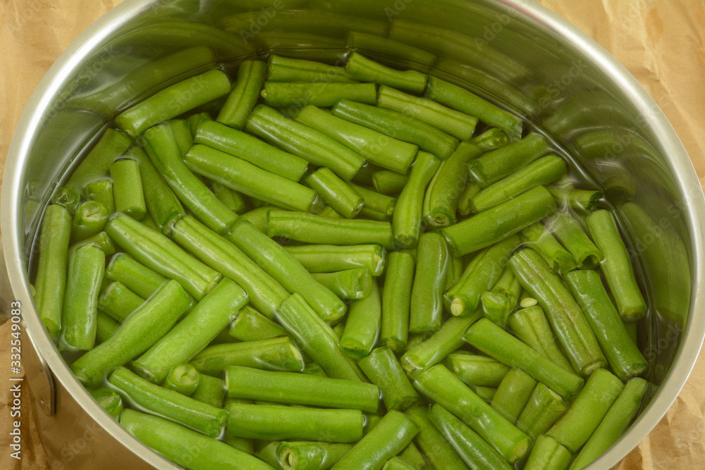 Fresh raw cut green beans in water inside stainless steel cooking pot Fresh raw cut green beans in water inside stainless steel cooking pot