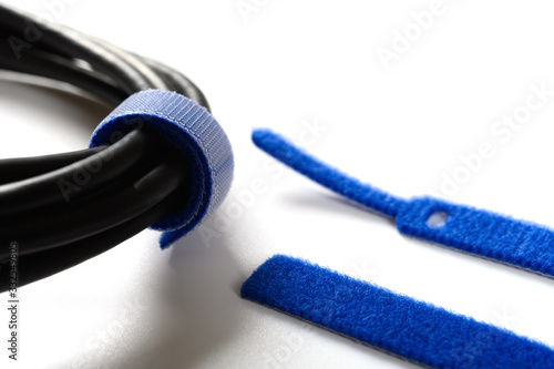 Bild auf Leinwand blue velcro cable tie and cable on white
