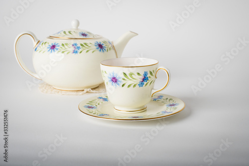 cup of tea with teapot and cup of tea on white background