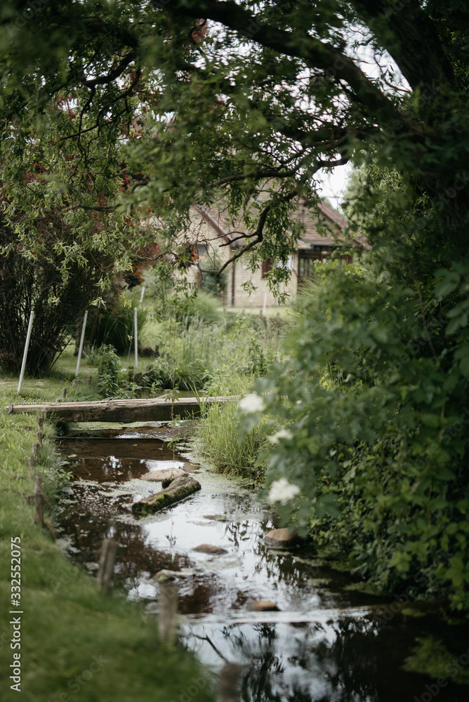 A small river near the house. Spring day in the countryside A small river near the house. Spring day in the countryside