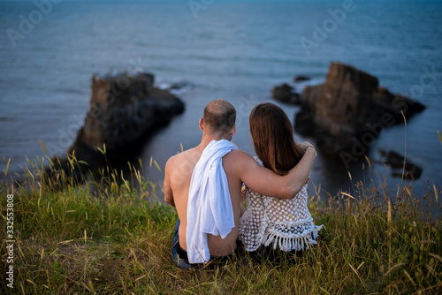 Back view of a couple in front of the sea view