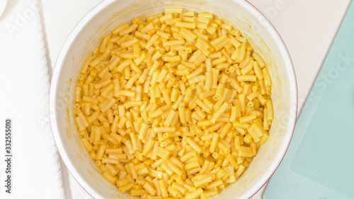 Creamy delicious macaroni and cheese close up in a bowl, view from above