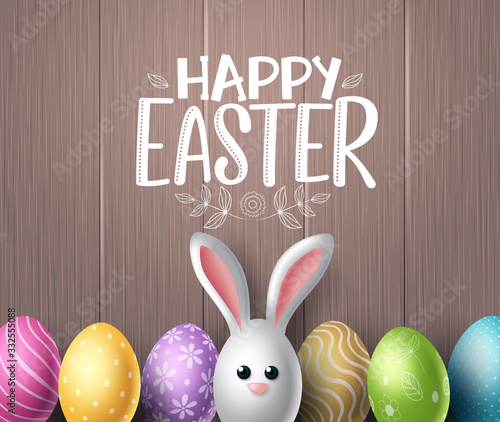 Happy easter vector background design. Happy easter text in wood textured space for text with colorful egg patterns and cute bunny rabbit in wooden background. Vector illustration. 