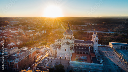 Fototapeta Naklejka Na Ścianę i Meble -  Aerial view of Madrid Cathedral Santa Maria la Real de La Almudena in Madrid, Spain and Royal Palace at sunset. Architecture and landmark of Madrid. Cityscape of Madrid