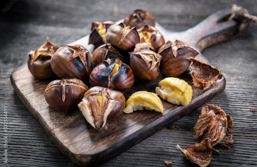 Roasted chestnuts on wooden background