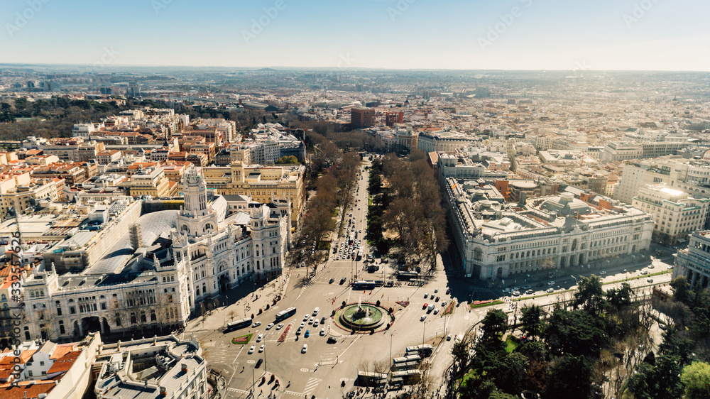 Aerial view of the important traffic intersection and the Plaza de Cibeles square with marble sculptures with fountains that has become an iconic symbol for the city of Madrid, Spain