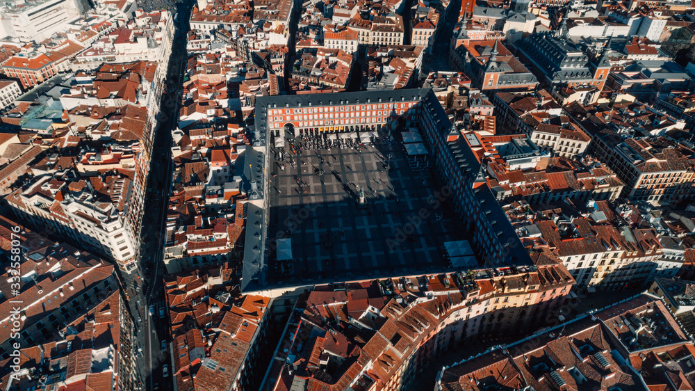 Fototapeta premium Beautiful sunny day in city,architecture and landmark of Madrid. Crowded center of capital of Spain.Aerial view of Plaza Mayor in Madrid,Spain. Plaza Mayor is a central plaza in the city of Madrid.