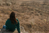 girl sitting on a cliff in Old Orhei Moldova