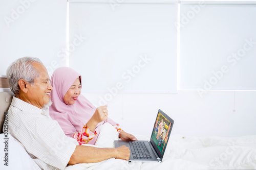 Grandparents watching video of their grandchild