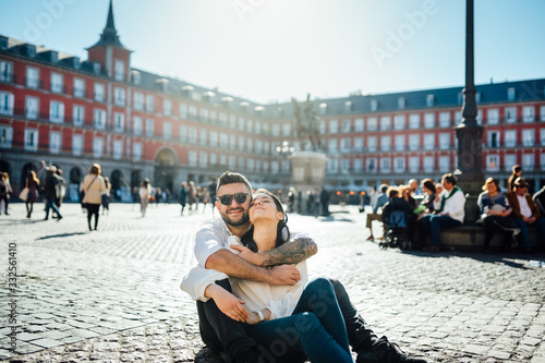 Visiting famous landmarks and places.Happy young couple tourists visiting famous Plaza Mayor square. Marid,Spain travel experience. Vacation in capital of Spain, blogger lifestyle.Europe honeymoon photo