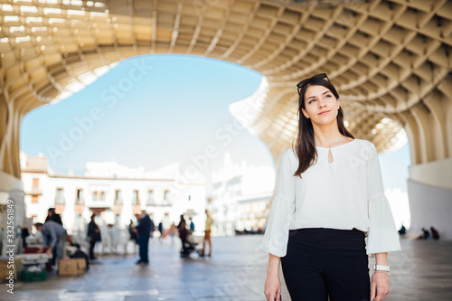 Happy female tourist visiting Setas de Seville aka Metropol Parasol, site seeing attractions.Vacation in south of Spain.Andalucia road trip