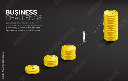 Silhouette of businesswoman walking on rope walk way to golden coin stack graph .Concept for business risk and challenge.