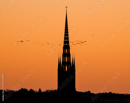 Photography Morning skyline at sunrise over the old town district Gamla Stan in orange light sky with profiles of houses and churches