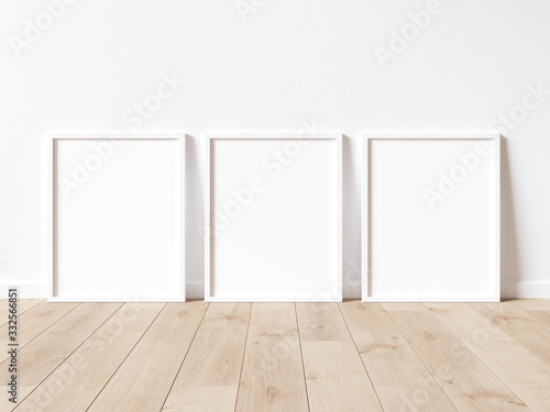 Fototapeta Naklejka Na Ścianę i Meble -  Vertical wooden frame poster on wooden floor with white wall. Wooden frame mock up. 3D illustrations.