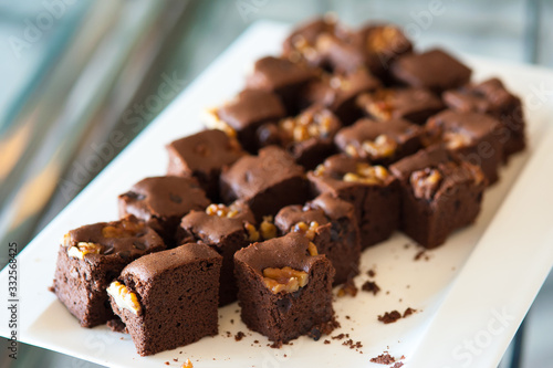 Walnut brownie stack, closeup chocolate cake in plate