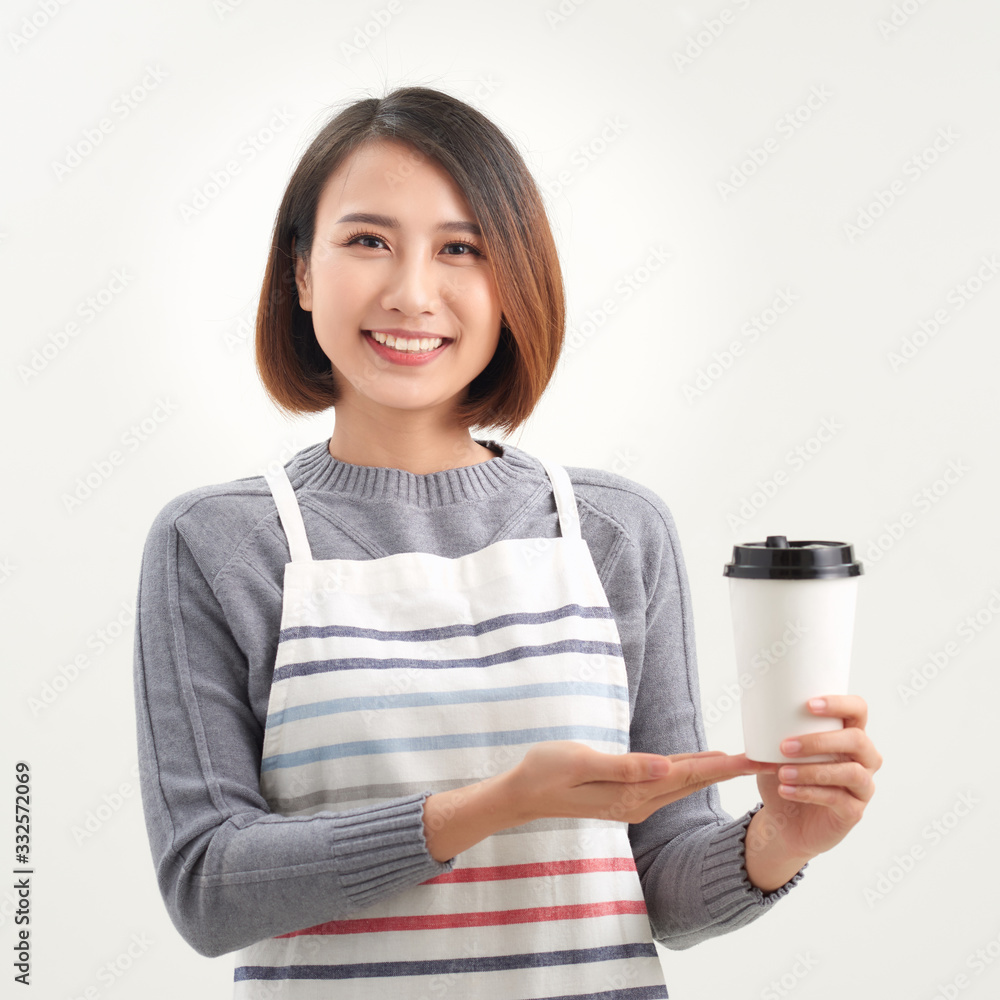 A waitress holding and serving a paper cup of hot coffee in cafe A waitress holding and serving a paper cup of hot coffee in cafe
