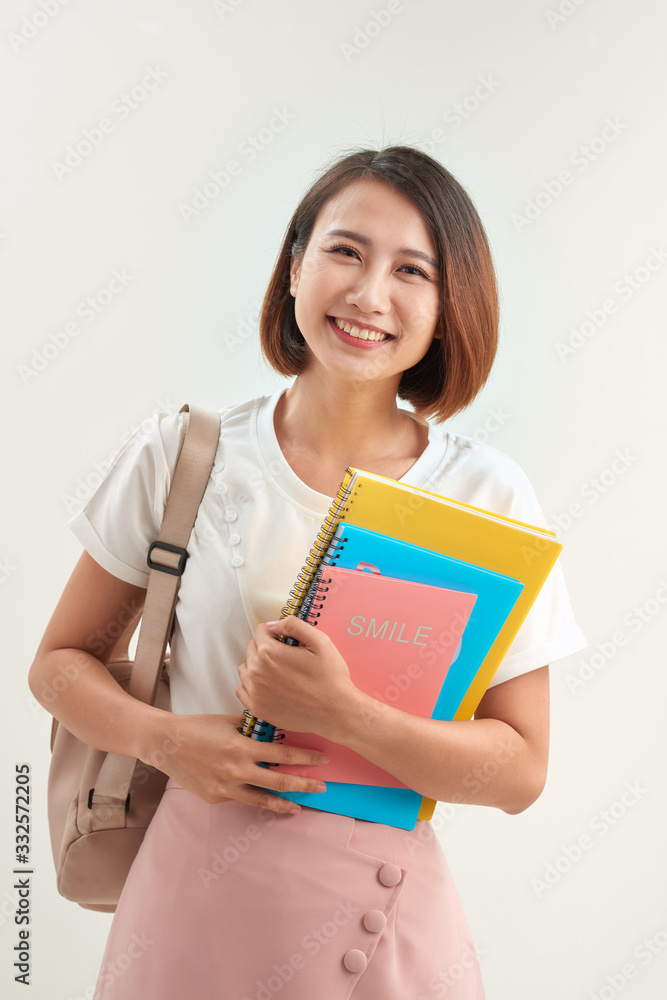 Young woman with books and backpack on white background Young woman with books and backpack on white background