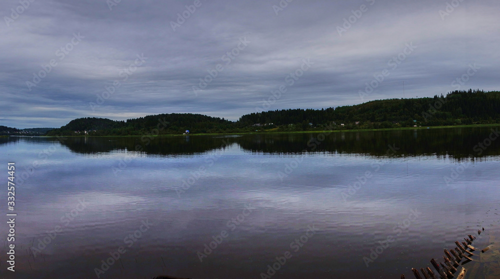 Panorama of the water landscape of Karelian nature.Panoramic view of the water surface: coniferous forest, smooth surface of the lake, open horizon. Russia, Karelia, Sortavala