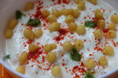 Boondi raita is a Indian raita made with spiced yogurt and boondi (crisp fried gram flour balls), Indian traditional food photo