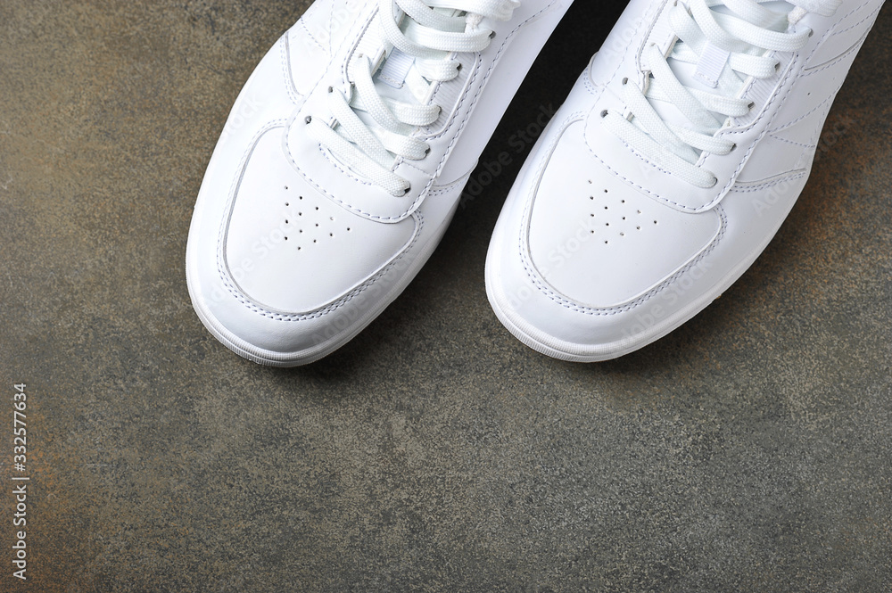 white sneakers on a gray background - background with space for text