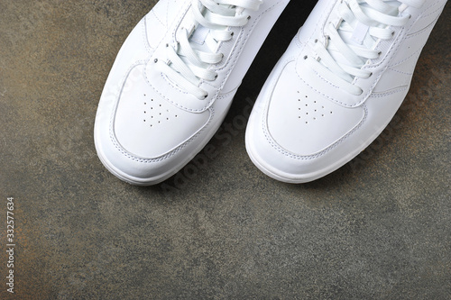 white sneakers on a gray background - background with space for text