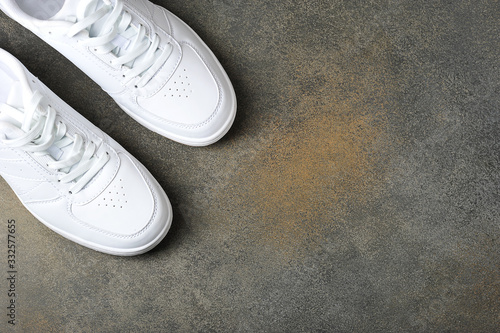 white sneakers on a gray background - background with space for text