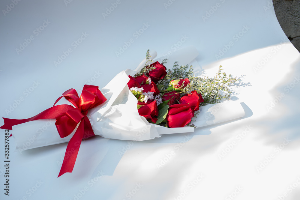 Hand holding a bouquet of beautiful red roses On a white background to congratulate and give as a gift instead of love.concept Hand holding a bouquet of beautiful red roses On a white background to congratulate and give as a gift instead of love.concept