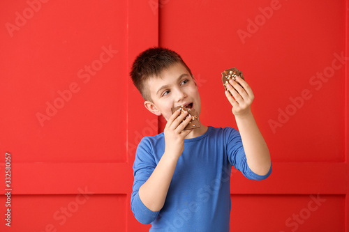 Cute little boy eating choc...